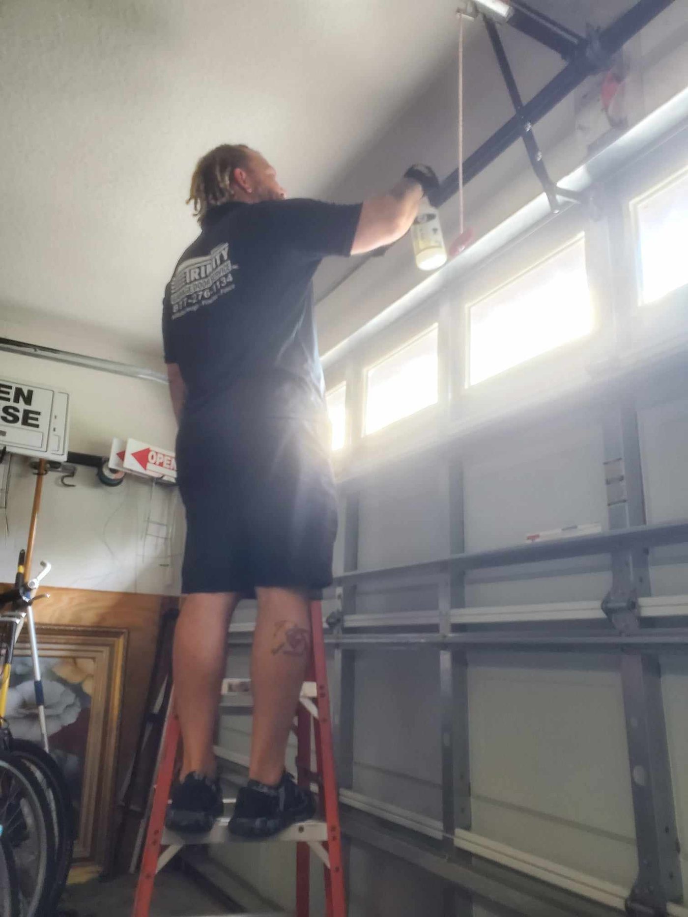 Trinity technician working on a garage door track