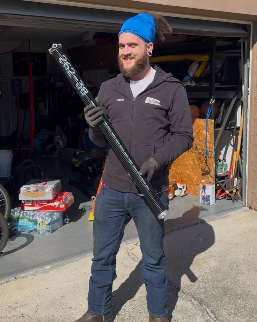 Trinity technician carrying a replacement torsion spring