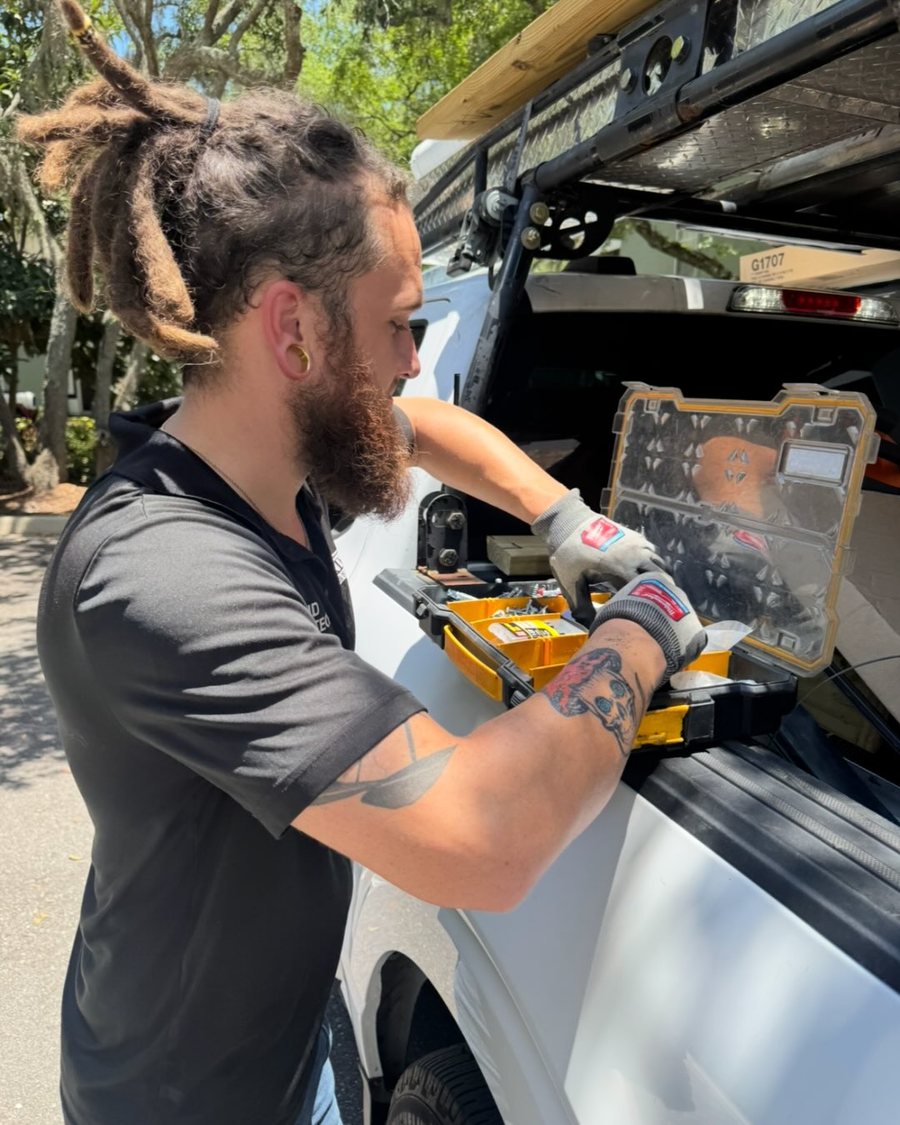 Trinity technician repairing garage door hardware