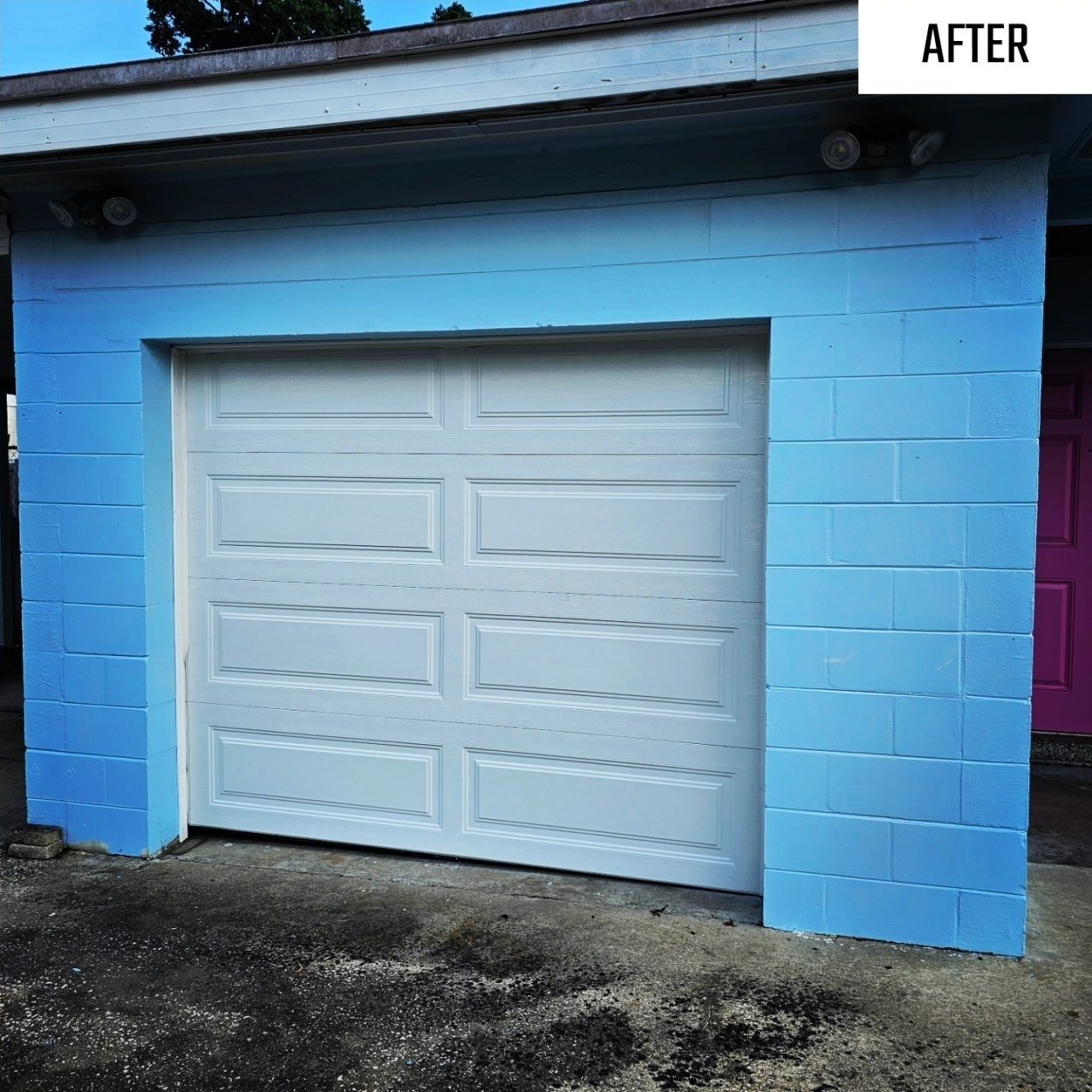 A fresh white garage door on a blue Florida home